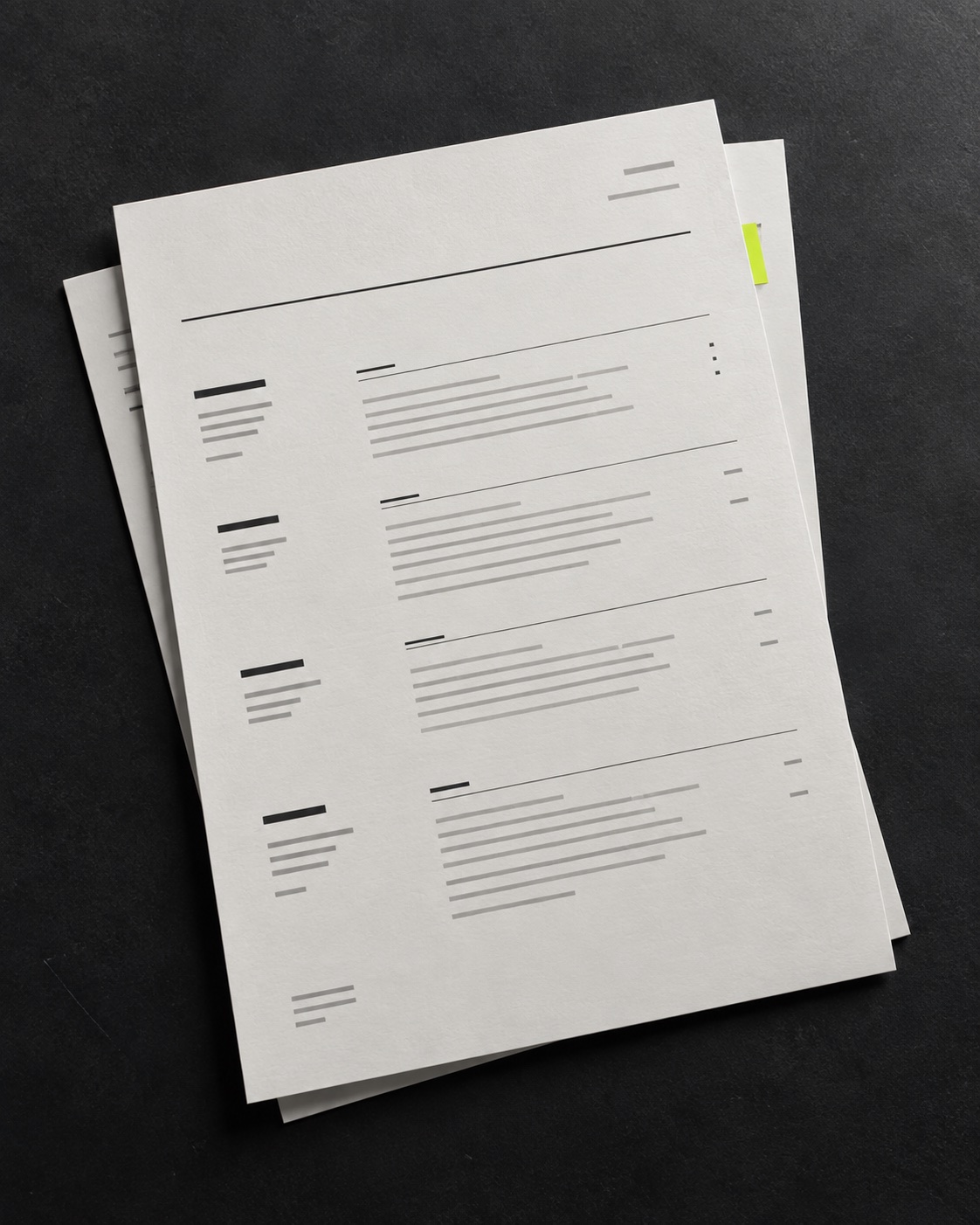 A clean, structured CV page on a charcoal desk
